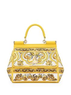 yellow/white
leather
Majolica pattern
gold-tone hardware
logo plaque
single rolled top handle
detachable shoulder strap
foldover top with magnetic fastening
main compartment
internal slip pocket
full lining Fancy Purses, Hardware Logo, Yellow Handbag, Medium Sized Bags, Dream Bags, Printed Handbags, Victorian Home, Woman Bags Handbags, Dolce E Gabbana