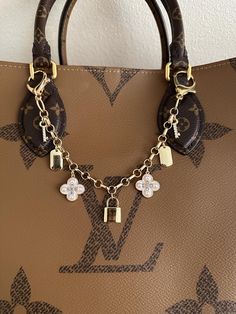 a brown louis vuitton bag with charms on it