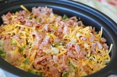 a black bowl filled with food on top of a table