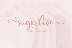 the word sugar love is written in cursive font on a white shirt hanging from a clothes rack