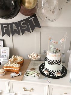 a table topped with lots of cakes and desserts