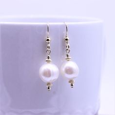 "Simple freshwater pearl earrings are complimented with rich polished gold filled corrugated bead spacers and balls which create a visually pleasing stacked and balanced streamlined design. These simple minimalistic dangle earrings are high polished, and have hammered gold filled French ear wires with decorative beads for a polished finished look. These earrings match all my gold filled necklaces and bracelets so you can coordinate and wear multiple items together. Metal - gold filled findings G Elegant Beaded Earrings With Pearl Charm For Gift, Elegant Hypoallergenic Round Bead Earrings, Elegant Pearl White Beaded Earrings As Gift, Pearl Beaded Drop Earrings, Elegant Beaded Drop Earrings With Pearl Charm, Elegant Pearl White Beaded Earrings With Pearl Drop, Classic Dangle Earrings With Pearl Charm, Pearl Beaded Drop Earrings With Pearl Charm, Pearl Beaded Drop Earrings For Pierced Ears