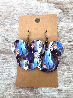 two disney princesses are shown on the back of these earring earrings, which have been