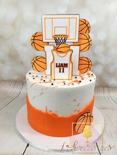 a cake decorated with an orange and white basketball theme