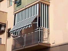 an awning on the side of a building with balcony and balconies above it