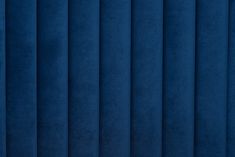 a blue wall with vertical blinds in the background