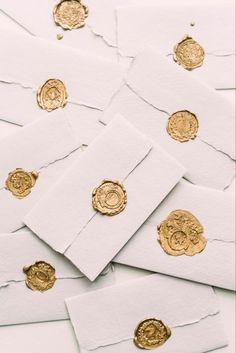 some gold coins are laying on top of white paper