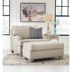 a living room scene with focus on the chair and ottoman