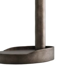 a large metal object with a round base on the top and one leg extended to the ground