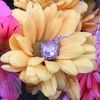 a bouquet of flowers with a diamond ring on it