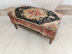 an ottoman sitting on top of a wooden floor