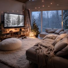 a living room filled with lots of furniture and a flat screen tv mounted to the wall