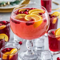 a glass filled with cranberry lemonade and garnished with orange slices