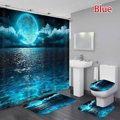 a bathroom with a blue shower curtain and rugs on the floor next to it