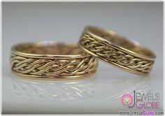 two gold wedding rings with intricate designs on them