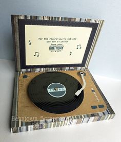 an old record player with a birthday card in the back and music notes on it