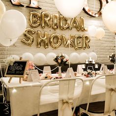 the bridal shower table is set up with balloons