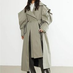 Elevate Your Style with Our Chic Trench Coat Step into the new season with confidence and style in our Chic Women's Double-Breasted Trench Coat. Perfectly blending elegance and functionality, this trench coat is a must-have for fashion-forward women. Crafted for versatility, it's ideal for all seasons, ensuring you stay stylishly protected against the elements year-round. Product Features Our trench coat boasts an array of features designed to enhance your look and comfort: Material: High-quality blend of cotton and polyester, offering both comfort and durability. Design: Slim fit with a sophisticated double-breasted closure and a turn-down collar. Unique Hem: An irregular hemline adds a modern twist to the classic trench style. Adjustable Fit: Equipped with a drawstring for a customizable Look Trench, Gothic Trench Coat, Women Trench Coat, Double Breasted Trench Coat, Irregular Hem, Chic Woman, Gray Green, Elevate Your Style, Full Sleeve