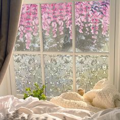 a window with pink flowers in the background