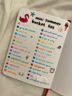 the mini summer bucket list is open on top of a white sheet with a red pen