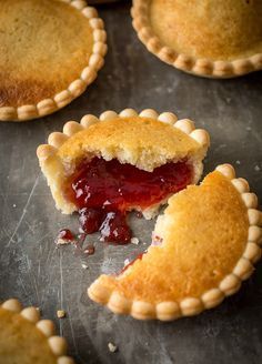 several small pies on a baking sheet with one slice cut out and the rest half eaten