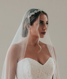 a woman in a wedding dress wearing a veil