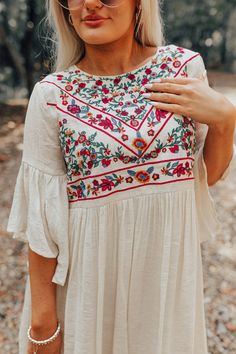 You won't find a prettier piece to wear while sipping "cocktails in Costa Maya" than this adorable cream hued dress featuring lightweight breezy material with an intricately embroidered bodice, loose half sleeves with oversized flared cuffs, a keyhole accented upper back with a button closure, and a relaxed skirt silhouette that falls into a straight mid-thigh length hemline! We have styled this cutie with a woven platform heel and clutch, but you can also wear it with "The Alaya Wedge in Golden Short Sleeve Embroidered Vacation Dress, Embroidered Summer Dress For Garden Party, Summer Embroidered Dress For Garden Party, Beige Half Sleeve Beach Dress, Spring Embroidered Half Sleeve Dresses, Spring Beige Embroidered Dress With Embroidered Hem, Spring Folk Embroidered Dress With Embroidered Sleeves, Beige Half Sleeve Summer Dress, Half Sleeve Embroidered Spring Dress