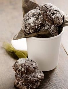 some cookies are in a white cup on a table