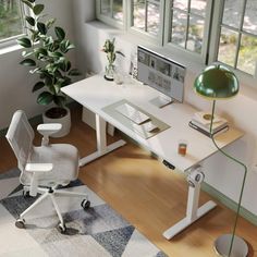 a white desk with a computer on it and a green lamp next to the window