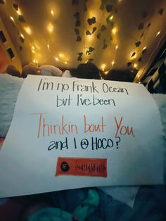 a sign that is on the bed with lights in the background