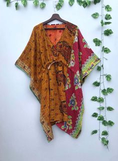 Indian Handmade Vintage Kantha Quilt Kaftan, Women Wear Boho Kaftan, Bridal Party Wear, Nightie, Mother's Day Gift, Boho Handmade Vintage Kantha Dress Kaftan This stunning Vintage Kantha Dress is made from old recycled sarees with running kantha stitch by women from rural areas of Rajasthan. The dress is full sleeve and knee length with a loose fit making it perfect for different occasions. This beautiful hand made hand stitched jacket / kaftan robe is truly one of a kind and unique in all ways. This is a beautiful use of up-cycled fabric from vintage kantha quilts. With a REVERSIBLE style, and use of vintage kantha quilts, this has a lovely thicker weight to it Made from 100% vintage fabric Length - 42" Inches (Approx.) Bust/chest size - Free Size ( Drawstring ) V Shape Neck Which is 10" Bohemian Multicolor V-neck Sets, Traditional Drape Kaftan For Diwali Festival, Bohemian Summer Kaftan With Dupatta, Traditional Multicolor V-neck Kimono, Festival Kaftan With Dupatta For Diwali, Diwali Festival Kaftan With Dupatta, Bohemian Festival Kaftan With Dupatta, Bohemian Kaftan With Dupatta For Festivals, Bohemian Kaftan With Dupatta For Navratri