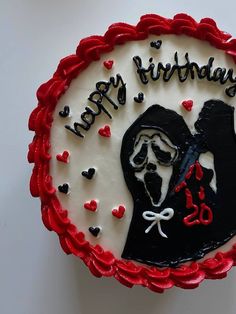 a birthday cake with an image of a man in the middle and hearts around it