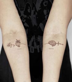 two people with matching tattoos on their arms, one has an arrow and the other has a flower