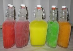 there are many bottles with different colored liquids in them