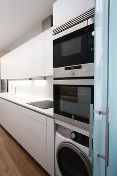 a kitchen with an oven, microwave and washing machine