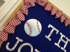 a baseball is displayed on a blue sign with red and white ribbons around it that says, i love you