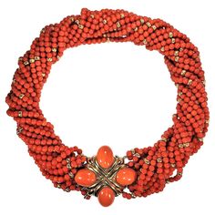 This magnificent mid-20th century front closing choker length torsade necklace, has, as the focal point in the front, a beautifully articulated 18k gold plate set with four large orange coral cabochons. The clasp alone measures 1 5/8inches long by 1 5/8 inches wide. The entire necklace connecting to this plate comprises fourteen strands of vivid orange Mediterranean coral beads all with an approximate 3.75mm diameter and with 4mm gold beads interspersed throughout. When twisted to their proper length for wear, the coral strands have a total diameter of approximately 7/8 inches making them appear very, very substantial. The matching pair of coral and gold earrings are shown in the last photo (sold separately). Total gross weight for the entire necklace is 163 grams. Metal: Gold,18k Gold Sto Woman Jewelry, Vintage Beads Necklace, Hippie Necklace, Orange Coral, Round Necklace, Coral And Gold, Coral Jewelry, Wedding Jewellery Necklace, Bridal Gold Jewellery