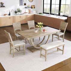 a dining room table with four chairs around it