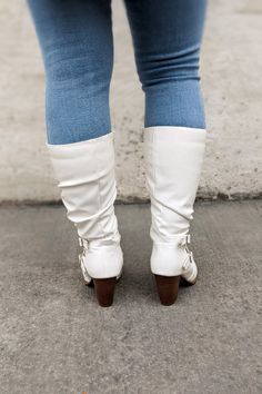 These boots are soooo "in" ladies! Knee high white boots with a criss cross buckle on the side will make any skinny jean look fabulous. These won't last long so grab them before your size is gone. Fits true to size. Taya is wearing 8.5 Knee high white boot with silver criss cross buckle. White Tall Boots With Jeans, White Tall Boots Flat, Knee High White Boots, High White Boots, White Knee-high Boots For Wide Calves, Fall White Knee-high Boots Medium Width, Cross Buckle, White Leather Knee-high Boots With Snip Toe, Western White Snip Toe Knee-high Boots