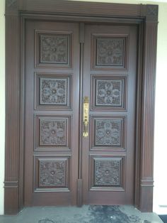 a large wooden door with intricate carvings on it's sides and side panels,