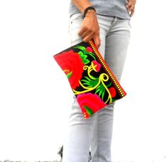 "This beautiful Embroidered Ethnic Rasta Pom Pom clutch bag Artist clutch bag comes with a top zipper closure and Internal zipper pocket inside the bag with fully black cotton lined interior This Beautiful handmade clutch bag Made from Hmong hill tribe fabrics. This Embroidered clutch bag can be a good idea for as a gift or can be use for your personal use this bag suitable for everyone. Measurements Size (Approx): 11\" X 7\" Color: Red green yellow Rasta Color embroidered Pom Pom bag This bag h Traditional Handheld Clutch For Everyday Use, Rectangular Festival Bag With Zipper Pouch, Traditional Floral Embroidered Clutch For Everyday, Traditional Floral Embroidery Clutch For Everyday, Traditional Bags With Zipper Pouch For Daily Use, Bohemian Rectangular Bag With Zipper Pouch, Bohemian Red Handmade Clutch, Handmade Bohemian Red Clutch, Multicolor Embroidered Festival Clutch