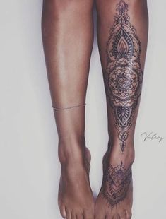 a woman's legs with tattoos on them and one leg in the shape of a flower