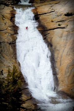 a person standing on top of a waterfall