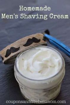 a glass jar with whipped cream in it next to a blue toothbrush on a table