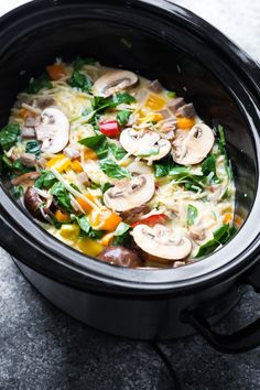 a crock pot filled with pasta and mushrooms