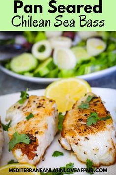 grilled fish fillets with parsley and lemon on a white plate next to a salad