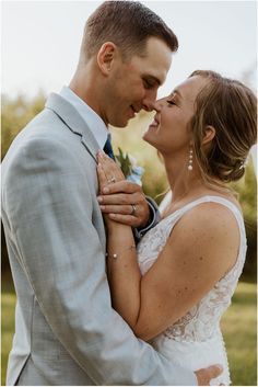 a bride and groom smile at each other