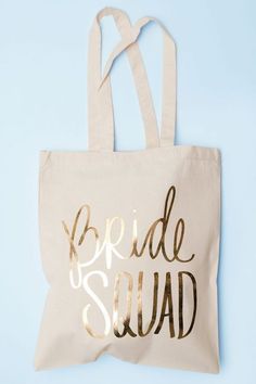 a tote bag with the words bride squad printed on it, against a blue background