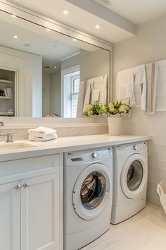 a washer and dryer in a white bathroom