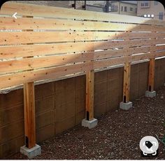 a row of wooden benches sitting next to each other on top of a dirt field